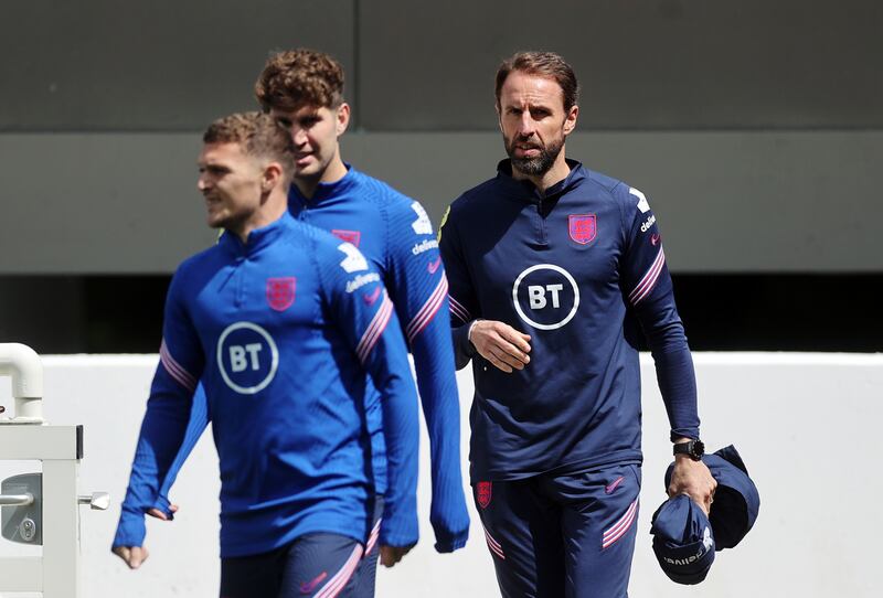 England manager Gareth Southgate, John Stones and Kieran Trippier arrive for a training session at St. George's Park.