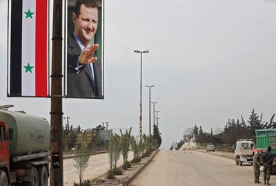 A picture taken during a guided tour organised by the Syrian Ministry of Information shows a poster of Syrian President Bashar al-Assad adorning the M5 highway connecting Aleppo to Damascus on February 18, 2020. In recent weeks, Syrian troops and allied forces backed by Russia have stepped up their offensive against jihadists and their rebel allies in Idlib and the neighbouring province of Aleppo. They have reconquered swathes of Idlib as well as key areas that have secured the strategic M5 highway connecting the country's four largest cities as well as the entire surroundings of Aleppo city for the first time since 2012. / AFP / LOUAI BESHARA
