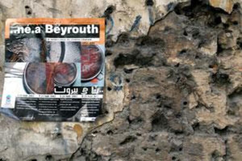 A poster promoting the 2002 Né à Beyrouth Festival of Lebanese Film is plastered on a bullet-riddled wall on the former Green Line in Beirut.