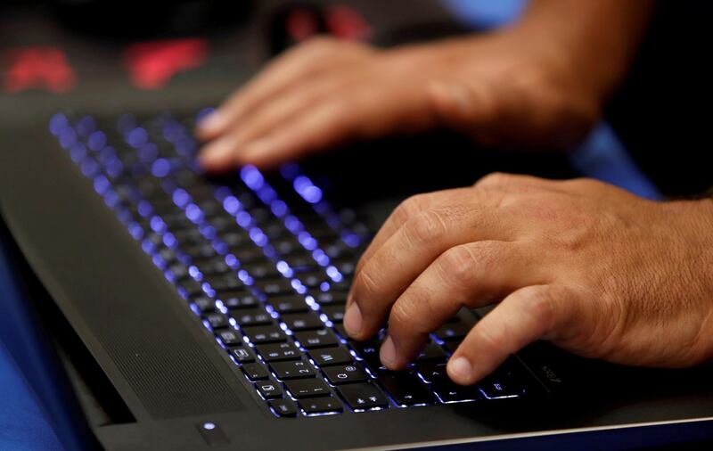 FILE PHOTO: A man types into a keyboard during the Def Con hacker convention in Las Vegas, Nevada, U.S. on July 29, 2017. REUTERS/Steve Marcus/File Photo