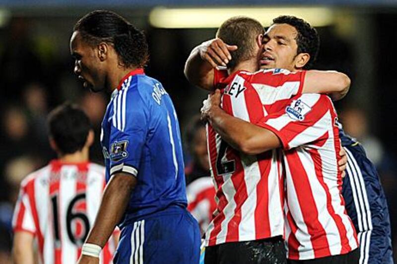 Sunderland pair Phil Bardsley, centre, and Kieran Richardson hug after inflicting a 3-0 defeat on Chelsea on Sunday.