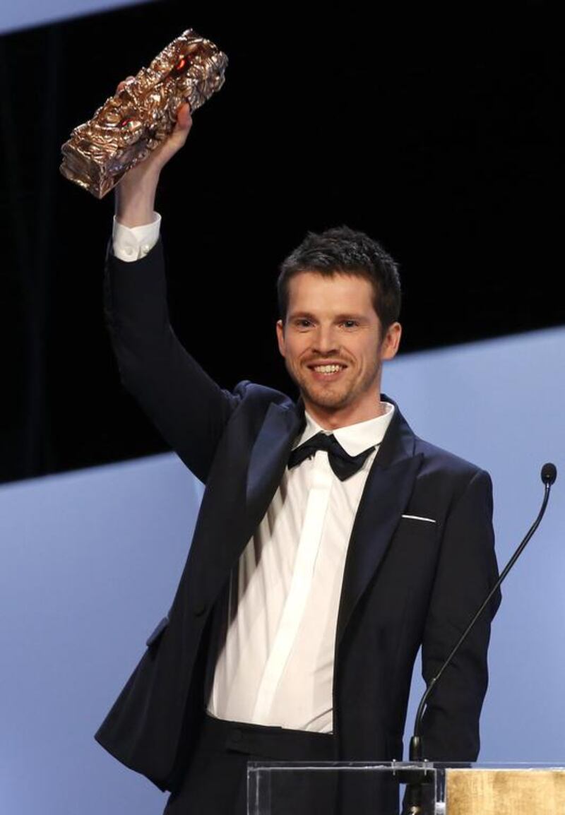 French actor Pierre Deladonchamps holds up his Most Promising Actor award. Etienne Laurent / EPA