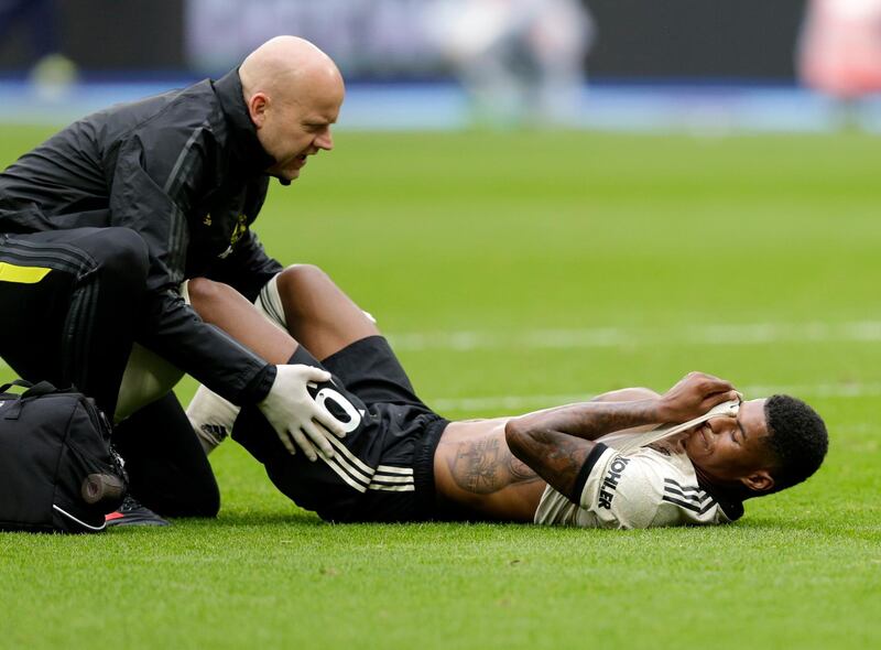 An injured Marcus Rashford receives treatment. Getty Images