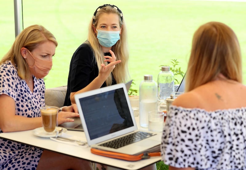 Dubai, United Arab Emirates - Reporter: Patrick Ryan. News. Teams of people are meeting to work remotely together in the same venues that are not offices. Jen Crowther, Catherine Broad (M) and Lauren Savill (R) work at a restaurant in Town Square. Wednesday, April 7th, 2021. Dubai. Chris Whiteoak / The National