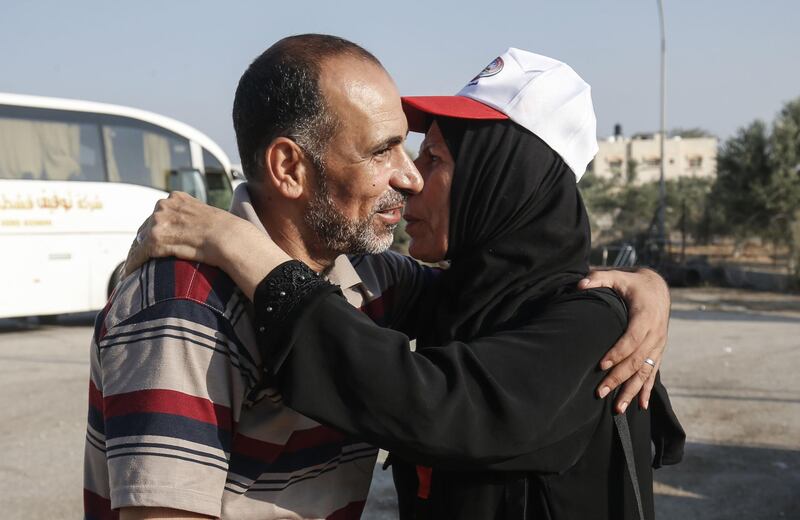A Palestinian pilgrim hugs a relative before boarding the bus at the Rafah border crossing between the Gaza Strip and Egypt.  AFP