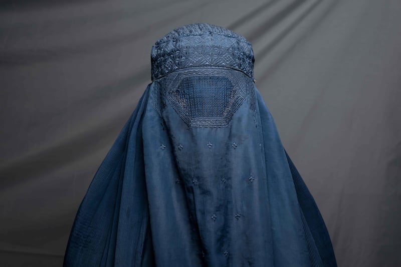 Shampoo factory worker Robina, 40, poses for a portrait in Kandahar. There is hardly a woman in the country who has not lost a male relative in successive wars, while many of their husbands, fathers, sons and brothers have also lost their jobs or seen their income shattered as a result of a deepening economic crisis.