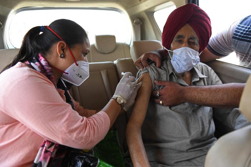 A health worker inoculates a man with a dose of the Covishield vaccine on the outskirts of Amritsar on May 24. AFP