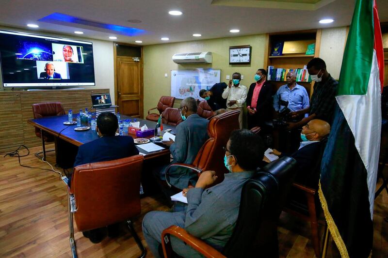 Sudan's Minister of Irrigation and Water Resources Yasir Mohamed takes part in a video meeting at the ministry in Khartoum on June 9, 2020, over the Grand Ethiopian Renaissance Dam. Egypt's President Abdel Fattah al-Sisi strongly rebuked Ethiopia, accusing Addis Ababa of stalling negotiations over a mega-dam being built on the Nile and moving ahead with plans to start filling the reservoir before reaching a deal. The agreement signed between Egypt, Ethiopia and Sudan paved the way for diplomatic talks after Addis Ababa sparked tension when it began construction of the Grand Ethiopian Renaissance Dam nearly a decade ago. / AFP / ASHRAF SHAZLY
