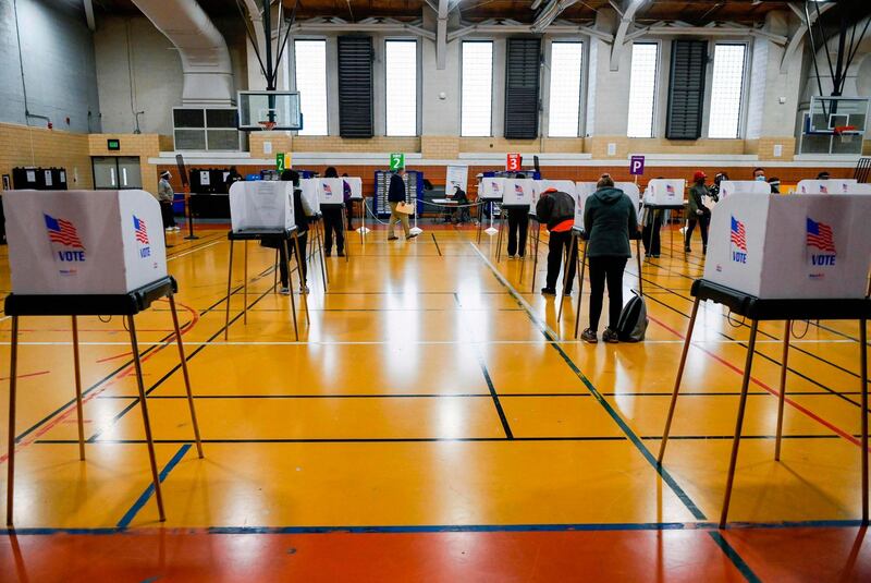 People vote at Morgan State University, on the second day of early voting in the US presidential race, in Baltimore, Maryland on October 27, 2020. / AFP / Andrew CABALLERO-REYNOLDS
