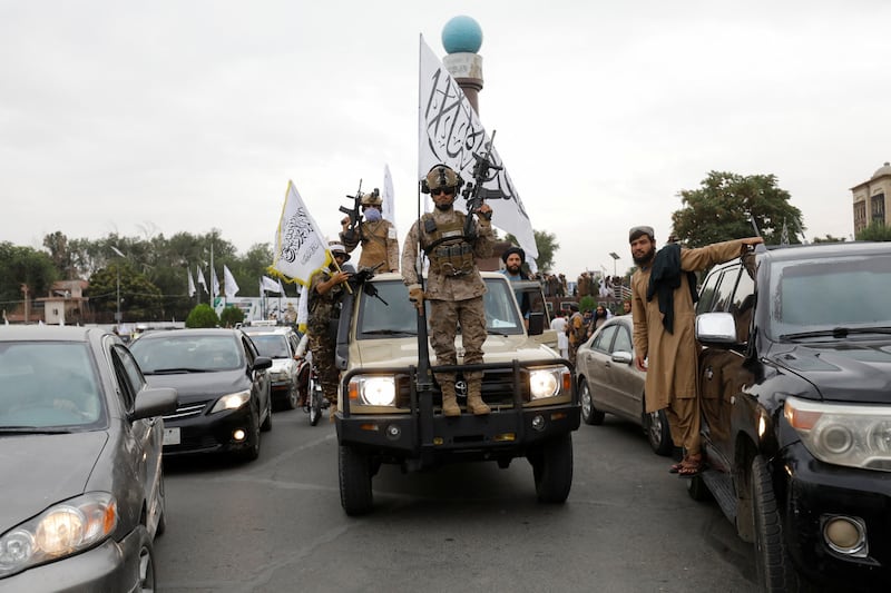 Taliban fighters drive in procession through the streets of the Afghan capital. Reuters