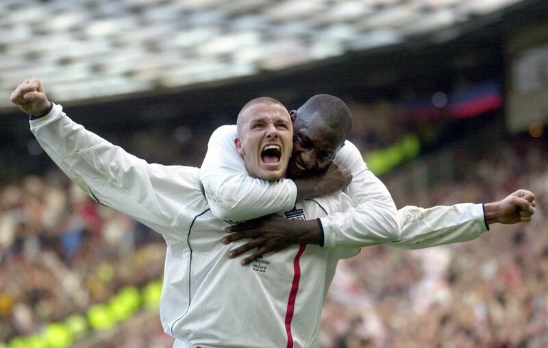 FILE - This is a Saturday, Oct. 6, 2001 file photo of England's captain David Beckham, left, as he  is congratulated by teammate Emile Heskey after scoring their second goal against Greece during their 2002 World Cup qualifying match at Old Trafford Manchester England. David Beckham is retiring from soccer after the season, ending a career in which he become a global superstar since starting his career at Manchester United. The 38-year-old Englishman recently won a league title in a fourth country with Paris Saint-Germain. He said in a statement Thursday May 16, 2013 he is "thankful to PSG for giving me the opportunity to continue but I feel now is the right time to finish my career, playing at the highest level."  (AP Photo/Adam Butler, File) *** Local Caption ***  Britain Soccer  Beckham Retires.JPEG-0c353.jpg