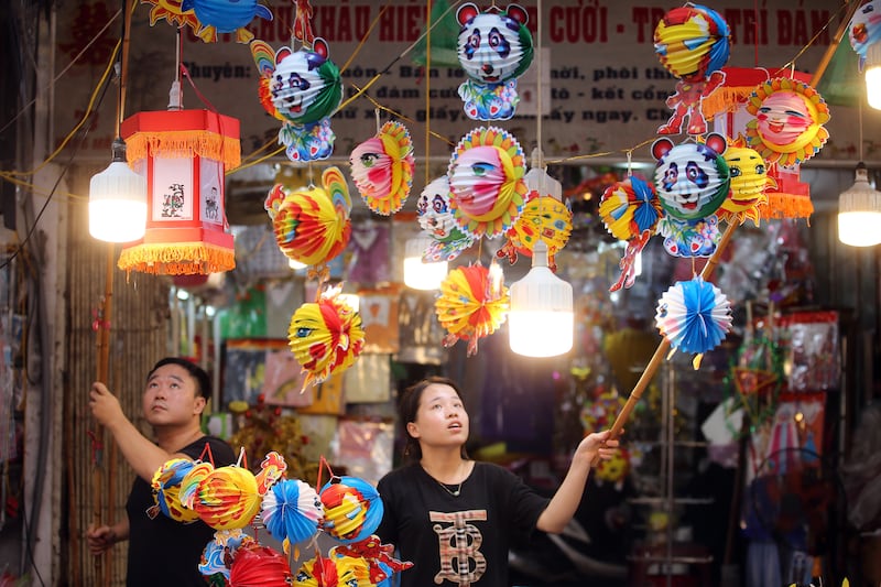 Vendors sell decorations for the Mid-Autumn Festival on a street in Hanoi, Vietnam. Also known as the Moon Festival, the celebrations involve lion dancers, lantern processions and mooncakes. This year the festival falls on September 10. EPA 