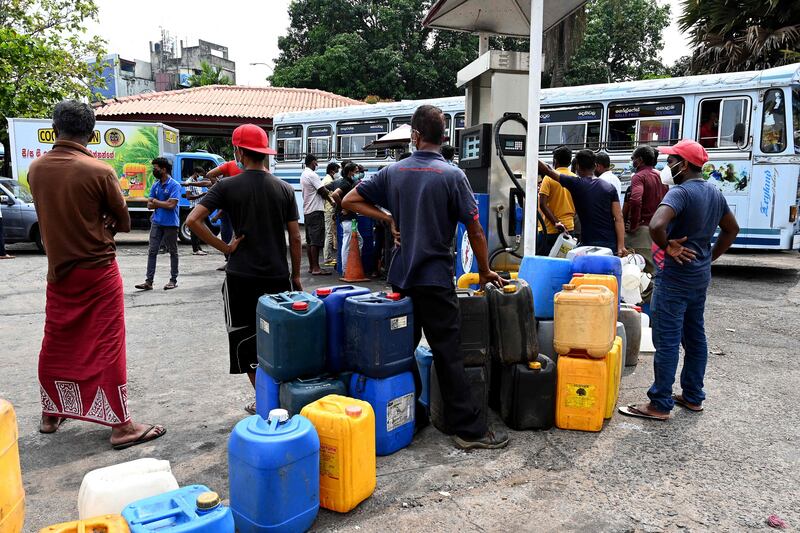 People queue to buy diesel at a fuel station in the Sri Colombo. AFP