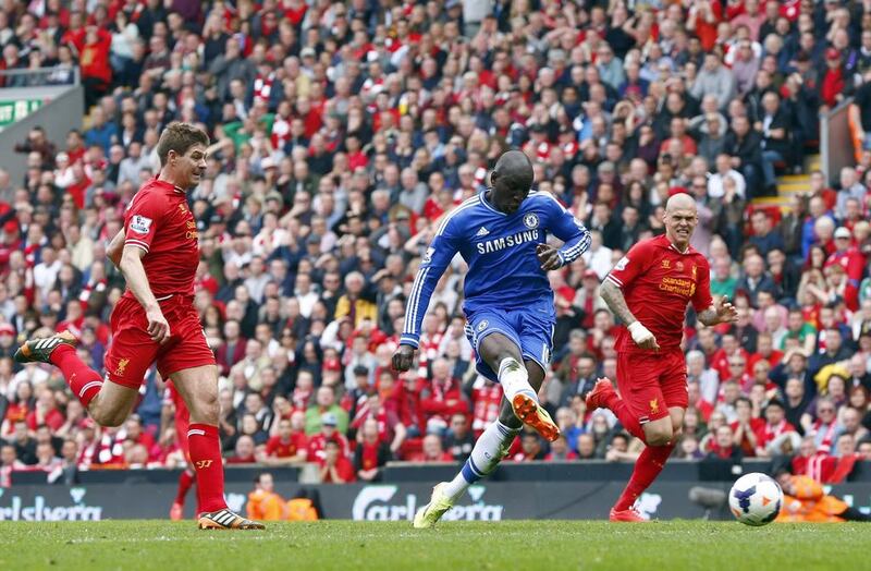 Demba Ba of Chelsea, centre, steals the ball from Liverpool’s Steven Gerrard, left, and scores in the final minute of the first half on Sunday. Darren Staples / Reuters

