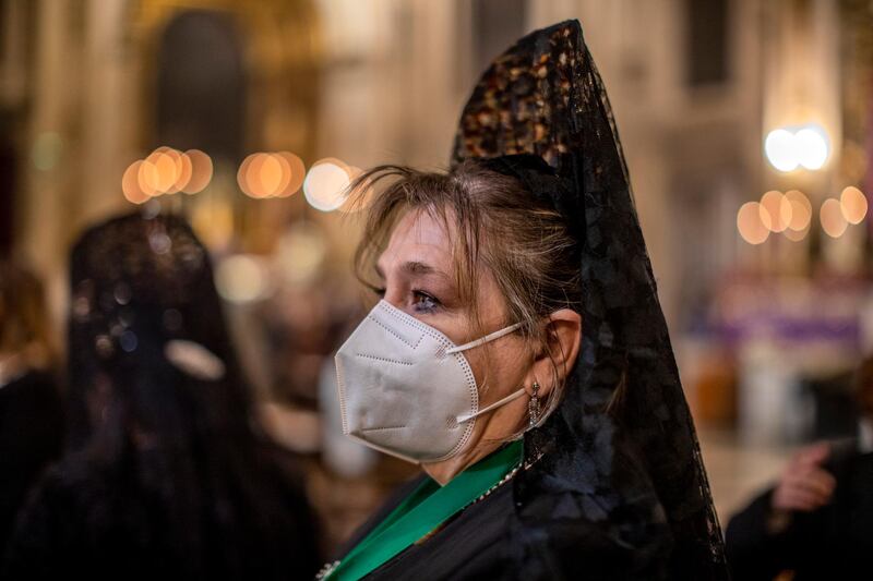 A woman wearing traditional 'mantillas' attend a mass at Collegiate church of San Isidore in downtown Madrid, Spain. For a second year running, Spain has had to cancel Easter Week processions to help stop the spread of COVID-19. AP Photo