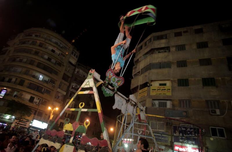 Egyptian Children play on a swing as they celebrate Moulid outside the Sayyeda Zeinab shrine, in Cairo, Egypt.EKhalil Hamra / AP Photo