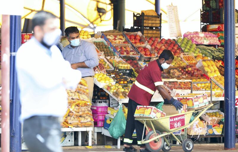 DUBAI, UNITED ARAB EMIRATES , June 9 – 2020 :- People wearing protective face mask and buying fruits and vegetables at the Al Awir fruit & vegetable market during the hot and humid weather in Dubai. (Pawan Singh / The National) For News/Standalone/Online/Stock