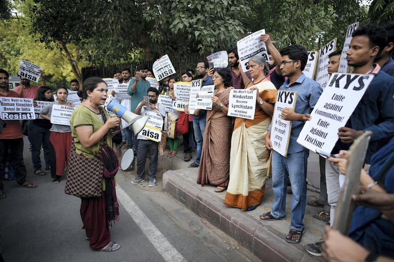 NEW DELHI, INDIA - JUNE 22: Members of All India Students Association (AISA) hold placards as they protest against the mob lynchings in the country, at Parliament street, on June 22, 2018 in New Delhi, India. Hailed from Hapurs Madhapur village, Qasim was lynched by a mob suspecting him of cow smuggler in Bajhera Khurd village in the Pilakhua town on Monday while his co-villager 65-year-old Mohammad Samiuddin sustained serious injuries in the assault. According to the victim family and villagers, the two were attacked over cattle theft rumors. However, the police said the assault preceded an altercation over a road accident. (Photo by Burhaan Kinu/Hindustan Times via Getty Images)