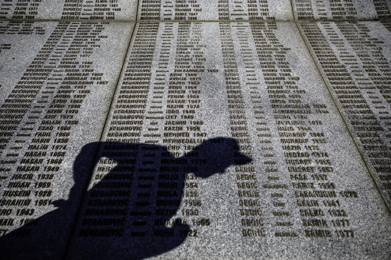 A man's shadow falls over ]the names of victims of Srebrenica genocide, at the cemetery in Potocari near Srebrenica, Bosnia and Herzegovina.  Getty Images