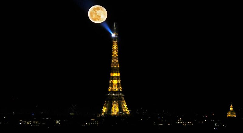 The waning gibbous moon appears in the sky near the Eiffel Tower. AFP