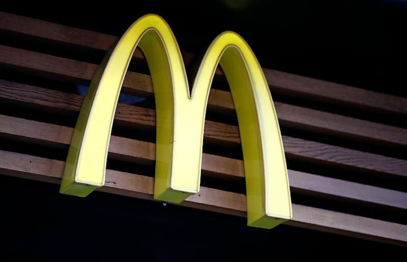 A logo of US burger chain McDonalds is pictured above a branch of the fast food restaurant in central London on September 4, 2017.
McDonald's staff have gone on strike for the first time in Britain in two of the chain's outlets in a dispute over pay and conditions. / AFP PHOTO / Tolga AKMEN