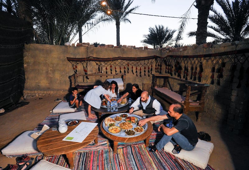 Tourists enjoy a meal made by Saqqara residents to improve their living conditions in thier village, in Giza, Egypt, April 27, 2021. Picture taken April 27, 2021. REUTERS/Shokry Hussien