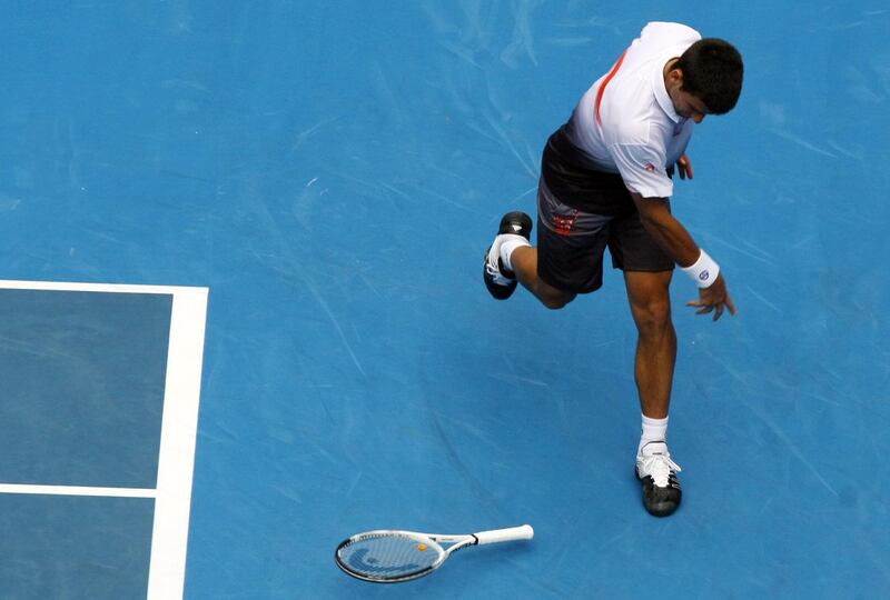 Novak Djokovic smashes his racquet to the ground after losing a point during his men's second round singles match against Marco Chiudinelli at the Australian Open in 2010. EPA
