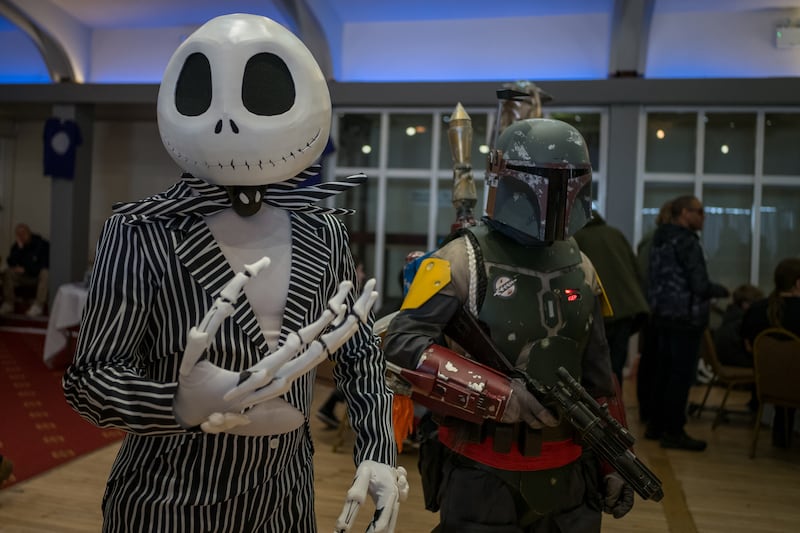 Visitors dressed as Jack Skellington from The Nightmare Before Christmas, left, and a Mandalorian
