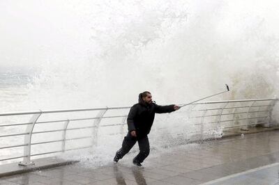 A man takes a selfie by a crashing wave on Beirut's Corniche as high winds sweep through Lebanon during a storm. Reuters