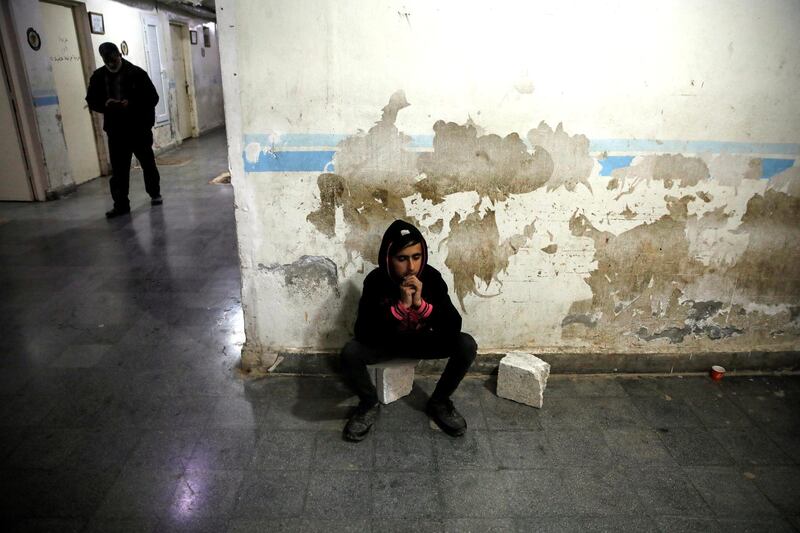 A relative of a wounded fighter waits for the end of his surgery in a hospital in Idlib, Syria. REUTERS