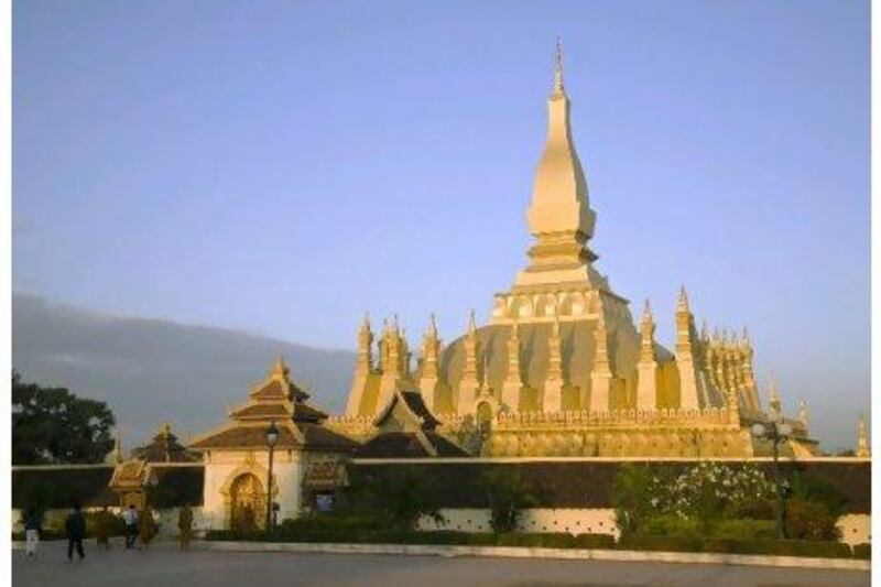 The golden-coloured Pha That Luang Buddhist Stupa in Vientiane, Laos, attracts tourists from around the world. Anders Blomqvist / Getty Images