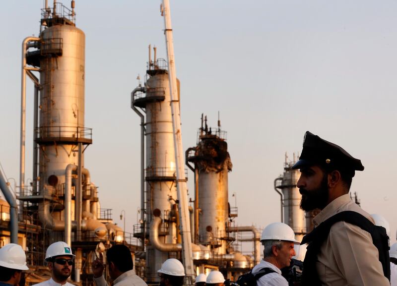 FILE - In this Sept. 20, 2019 file photo, a guard stands in front of Aramco's oil processing facility after the Sept. 14, 2019, attack on Aramco's oil processing facility in Abqaiq, near Dammam in the Kingdom's Eastern Province. A small instrument that two reports say was found inside drones which targeted the heart of Saudi Arabia's oil industry and those in the arsenal of Yemen's Houthi rebels, matches components recovered in downed Iranian drones in Afghanistan and Iraq. Conflict Armament Research said in a report released on Wednesday, Feb. 19, 2020, that these gyroscopes within the drones have only been found inside those manufactured by Iran. (AP Photo/Amr Nabil, File)