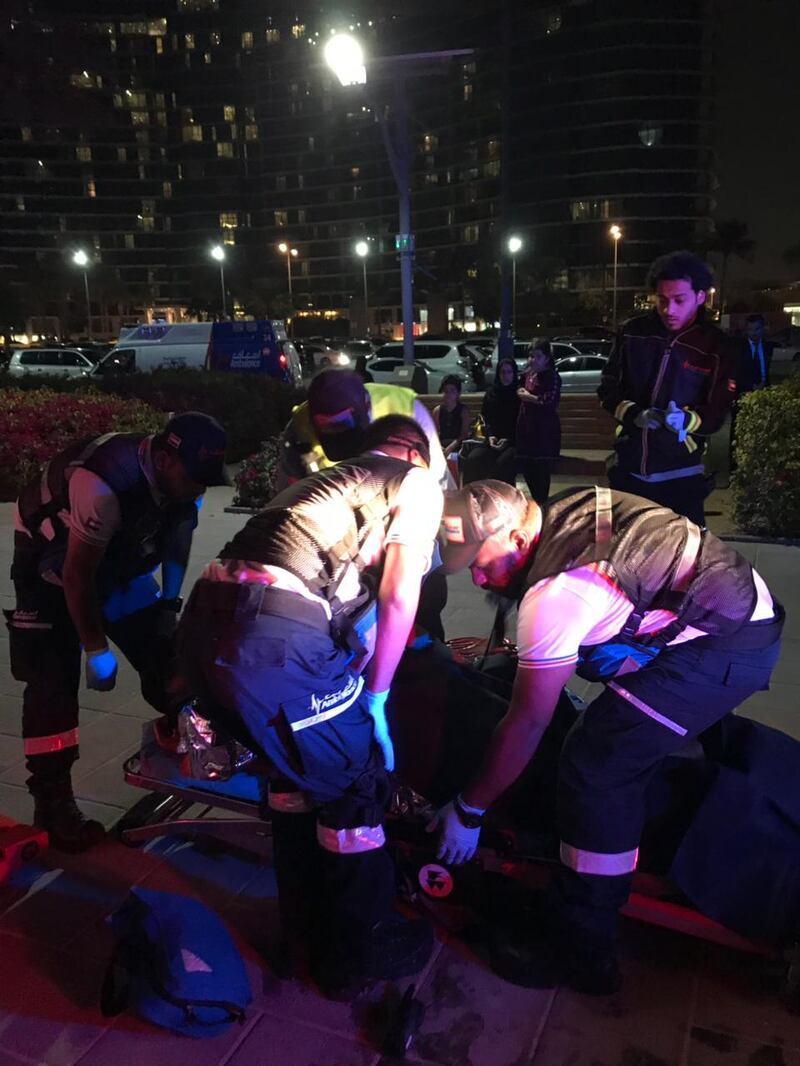 An injured family member is taken to hospital after their boat sailed into shallow waters under Business Bay Crossing this weekend. Courtesy Dubai Police