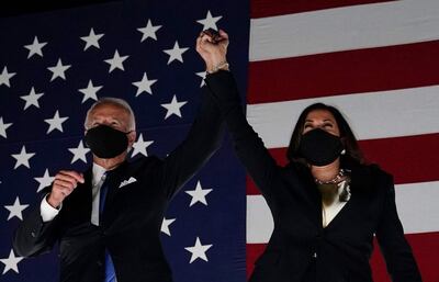 Former vice-president and Democratic presidential nominee Joe Biden (L) and Senator from California and Democratic vice presidential nominee Kamala Harris greet supporters outside the Chase Center in Wilmington, Delaware, at the conclusion of the Democratic National Convention, held virtually amid the novel coronavirus pandemic, on August 20, 2020.  / AFP / Olivier DOULIERY
