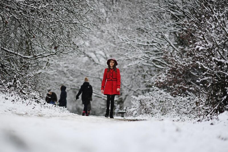 A young woman walks along a snowy path on Hampstead Heath in London, United Kingdom. Parts of the country saw snow and icy conditions as arctic air caused temperatures to drop. Getty Images