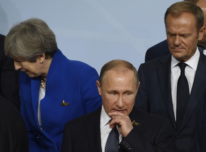 (FILES) In this file picture taken on July 7, 2017 Britain's Prime Minister Theresa May (L) Russia's President Vladimir Putin (C), and President of the European Council Donald Tusk (R) line up for the family photo on the first day of the G20 summit in Hamburg, northern Germany.
The United States and its European allies on March 26, 2018 expelled dozens of Russian diplomats in a coordinated action against Moscow which they accuse of poisoning an ex-spy in Britain.EU President Donald Tusk said 14 EU states had expelled Russian diplomats following a European Council decision last week to react to Moscow "within a common framework". / AFP PHOTO / Saul LOEB
