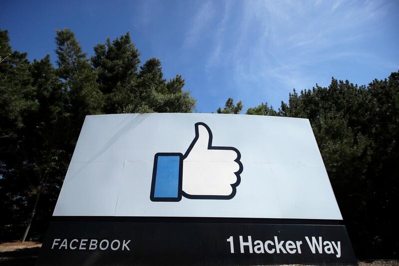 FILE - In this April 14, 2020 file photo, the thumbs up Like logo is shown on a sign at Facebook headquarters in Menlo Park, Calif. A federal judge has dismissed antitrust lawsuits brought against Facebook by the Federal Trade Commission and a coalition of state attorneys general, dealing a significant blow to attempts by regulators to rein in tech giants. (AP Photo/Jeff Chiu, File)