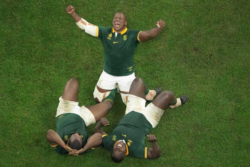 South Africa's hooker Bongi Mbonambi celebrates with teammates Ox Nche and prop Trevor Nyakane after victory in the 2023 Rugby World Cup Final. AFP