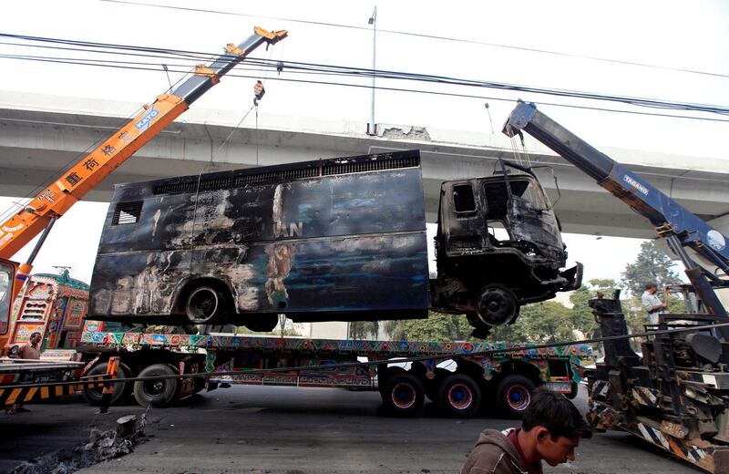 A wrecked police prison van is cleared from a road in Islamabada a day after the Tehreek-e-Labaik Pakistan Islamist political party called off nationwide protests. Faisal Mahmood / Reuters