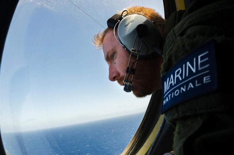 A French solider aboard an aircraft looking out a window during searches for debris from the crashed EgyptAir flight MS804, over the Mediterranean Sea. Alexnadre Groyer, Marine Nationale / AFP