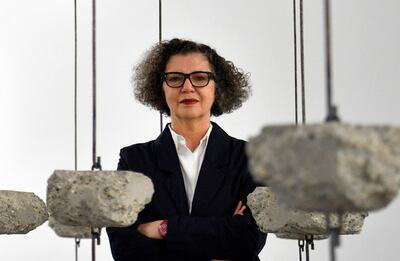 epa07848660 (FILE) - Palestinian-British artist Mona Hatoum poses with her artwork 'Remains to be Seen' as part of a multi-artist show at the White Cube Bermondsey in Lon​don, Britain, 11 September 2019 (reissued 17 September 2019). Mona Hatoum was announced as one of the five winners of the 2019 Praemium Imperiale Awards in the category 'Sculpture'. The Japan Art Association named the recipients of the global arts prize on 17 September.  EPA/NEIL HALL