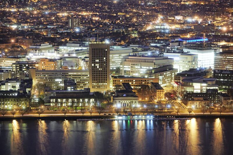 Elevated view of Boston at night with Charles River Basin and buildings of the Massachusetts Institute of Technology (MIT)