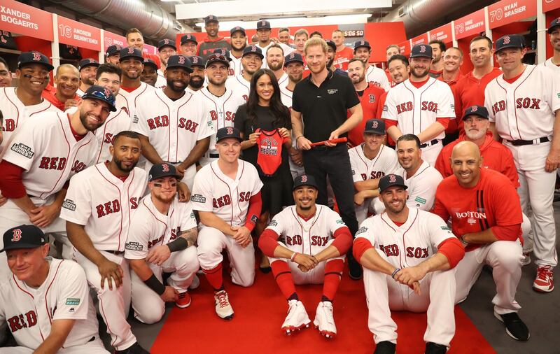 LONDON, ENGLAND - JUNE 29: In this handout image provided by The Invictus Games Foundation, Prince Harry, Duke of Sussex and Meghan, Duchess of Sussex join the Boston Red Sox in their Clubhouse and receive gifts for Archie ahead of their match against the New York Yankees at the London Stadium  in London, England. The historic two-game "You Just Cant Beat The Person Who Never Gives Up" series marks the sports first games ever played in Europe and The Invictus Games Foundation has been selected as the official charity of Mitel and MLB London Series 2019. Getty Images
