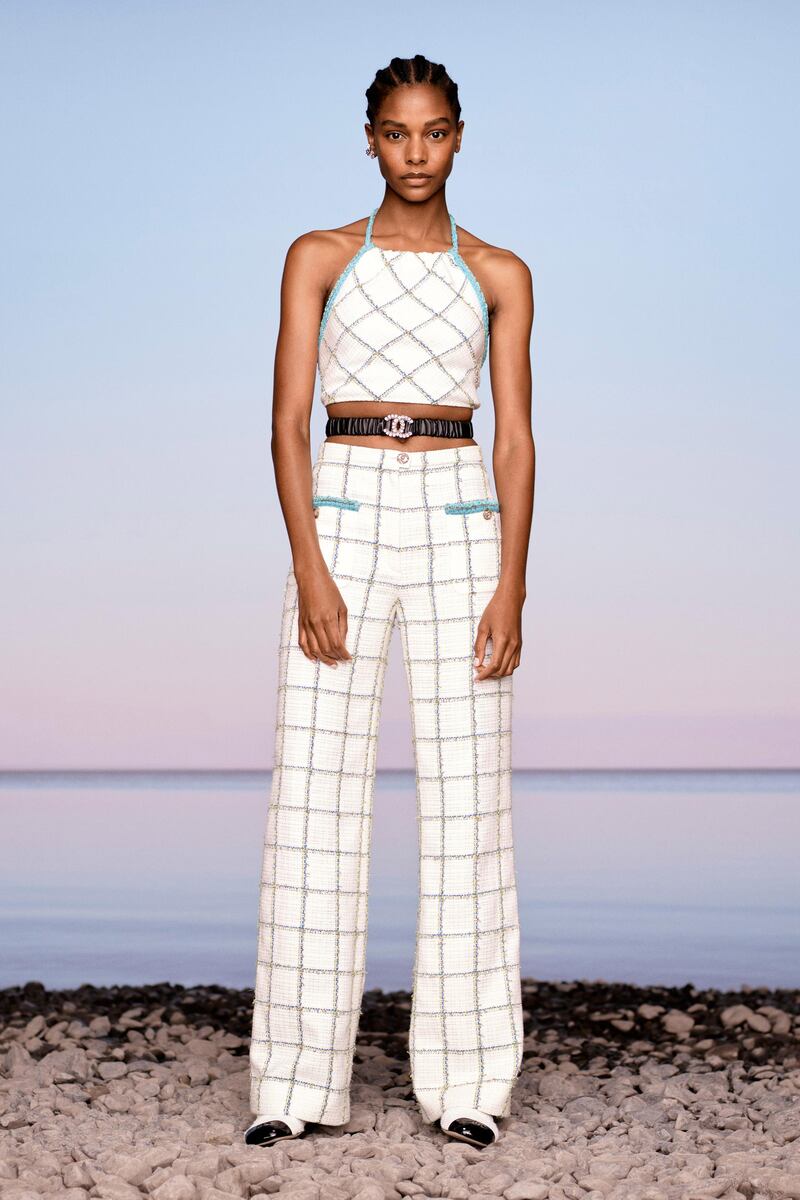 The house's checked tweed is made into a cropped, halter-neck top and high-waisted flares
