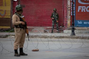 Indian paramilitary soldiers stand guard on a deserted road in Srinagar, Indian controlled Kashmir, after government forces killed a top rebel commander and his aide in Indian-controlled Kashmir on Wednesday. AP 