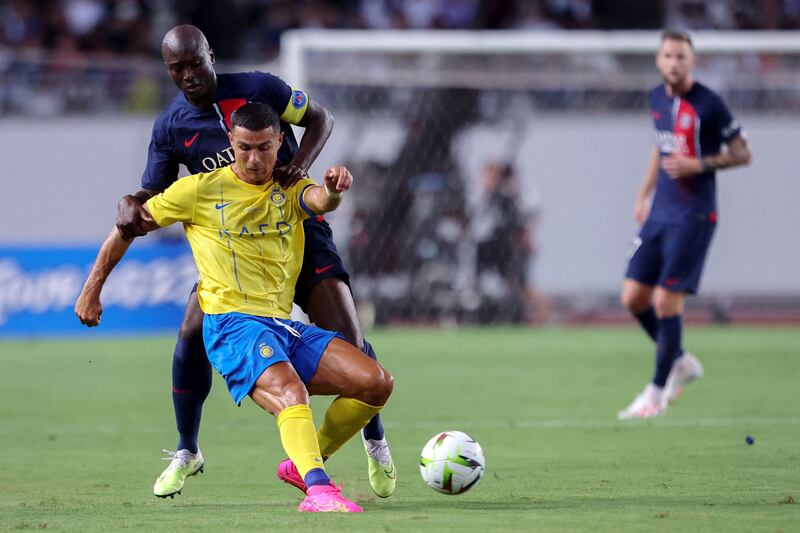 Paris Saint-Germain's Danilo Pereira fights for the ball with Al Nassr's Cristiano Ronaldo during their friendly at the Nagai Stadium in Osaka on Tuesday, July 25, 2023. AFP