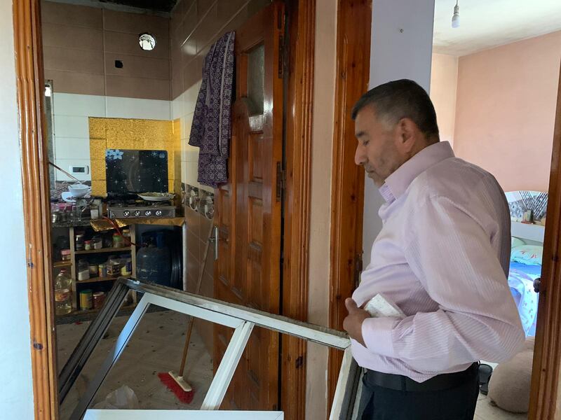Abu Alkas looks at the damage to his home caused by Israeli airstrikes in Gaza. Nagham Mohanna for The National