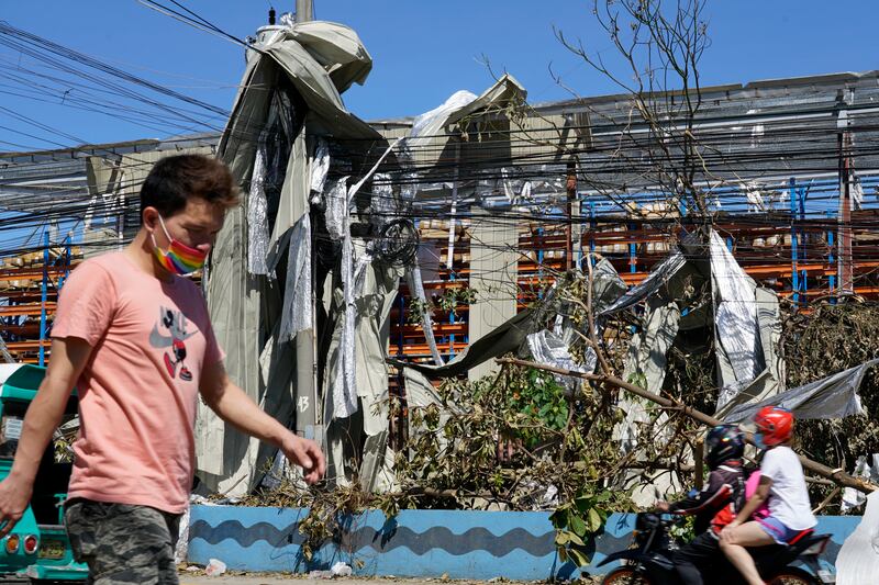 Metal sheets are wrapped around electrical posts after being blown around by Typhoon Rai in Cebu province. AP Photo