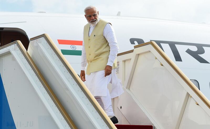 Indian Prime Minister Narendra Modi looks on from a plane on his departure at Bandaranaike International Airport in Katunayake, near Colombo, on June 9, 2019. India's Prime Minister Narendra Modi on June 9 made an unscheduled stop at a Catholic church bombed during the Easter suicide attacks ahead of his official welcome to Sri Lanka. / AFP / ISHARA S.  KODIKARA
