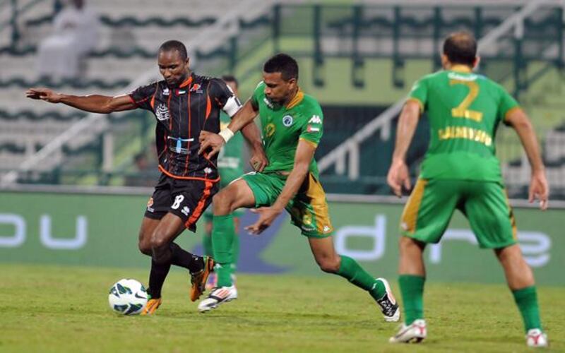 Dibba players struggling against Ajman during their recent Pro League match.